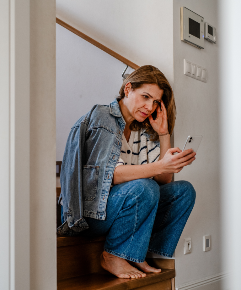 40 year old woman upset by text from ex sitting on stairs
